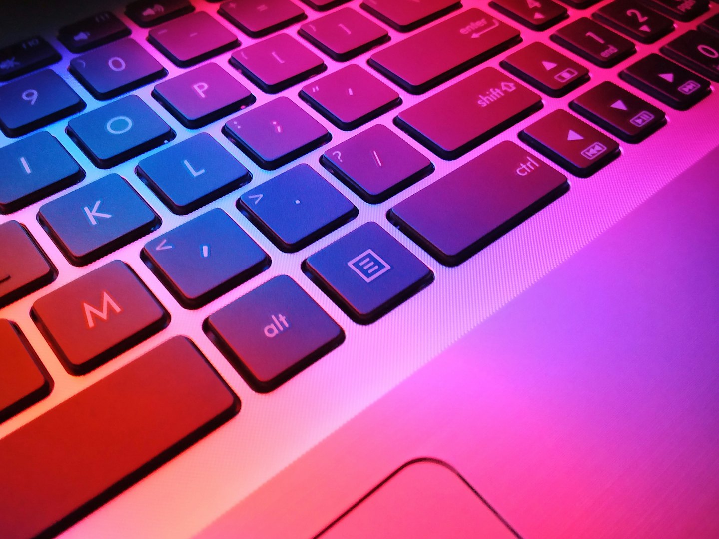 A laptop keyboard with colorful, futuristic lighting.